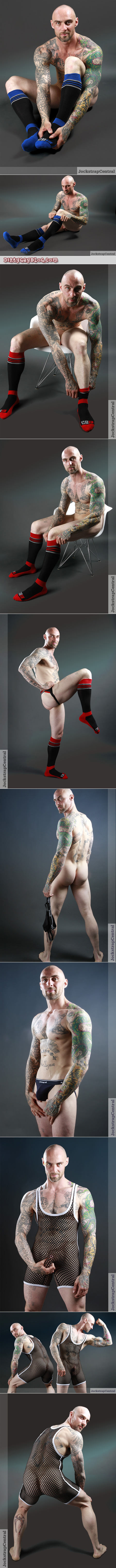 Muscular man with a shaved head and lots of tattoos modeling new and unusual jockstraps, underwear and OTC athletic socks.