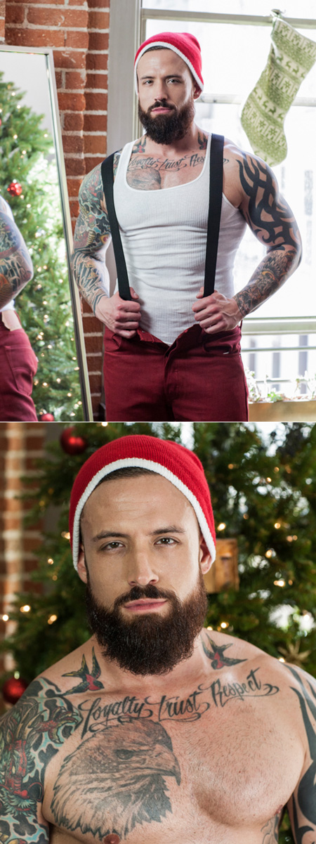 Sexy young muscle Santa covered in tattoos.