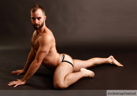 Furry muscle cub showing his muscles in a jockstrap.