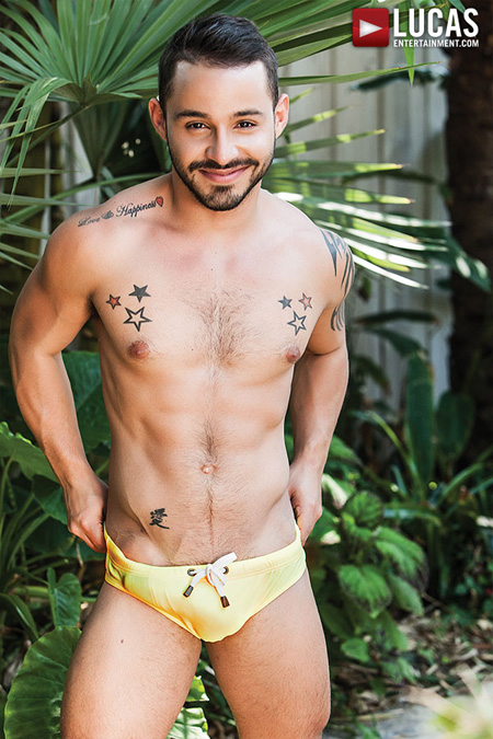 Short, muscular Latino with an erection in his tiny Speedo.